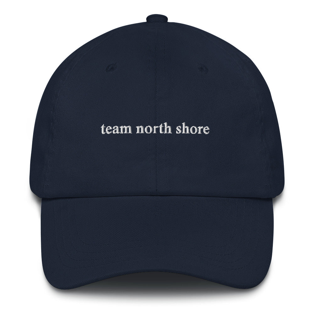 navy baseball hat that says "team north shore" in white lettering
