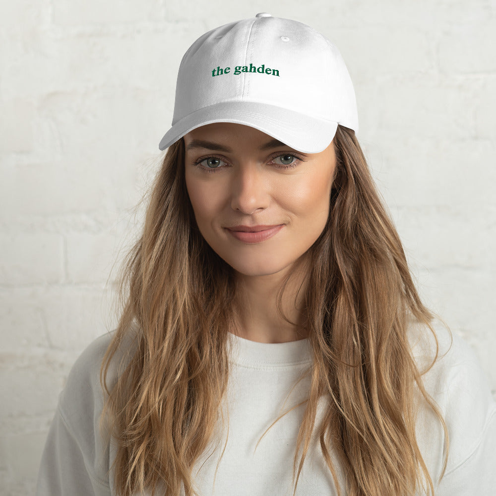 woman wearing white hat that says "the gahden" in green embroidery