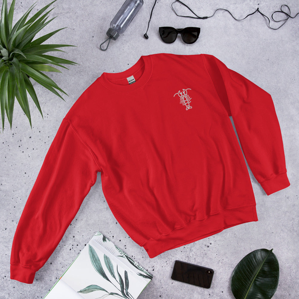 red crewneck with white lobster graphic in upper right corner