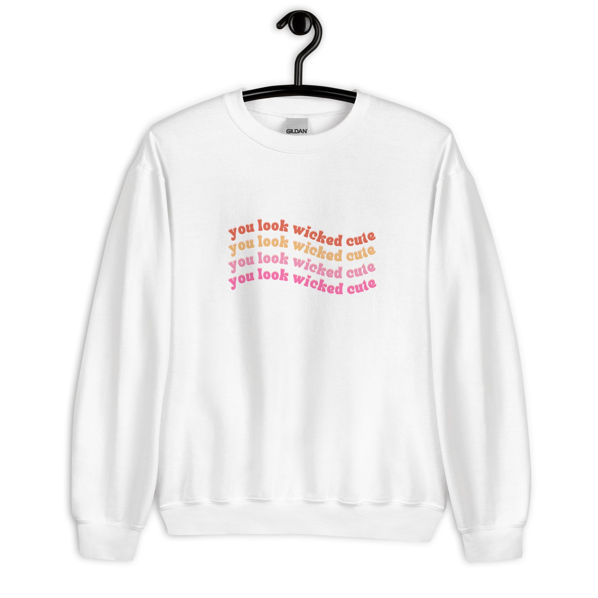 white crewneck that says "you look wicked cute" in red pink and orange lettering