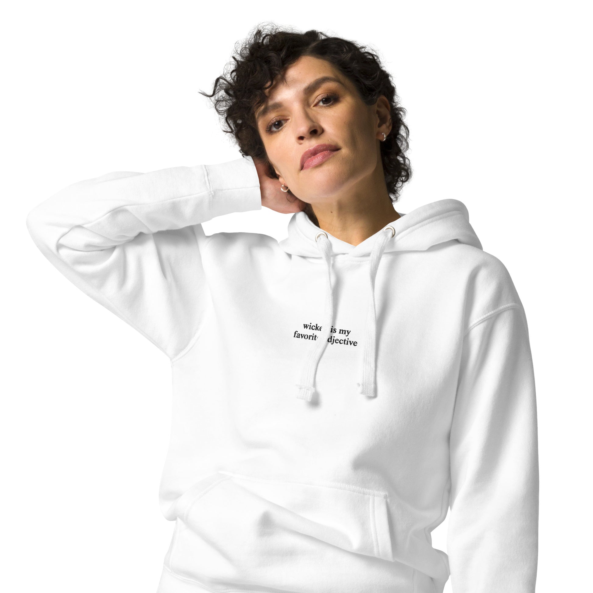 woman wearing white hoodie that says "wicked is my favorite adjective" in black embroidery