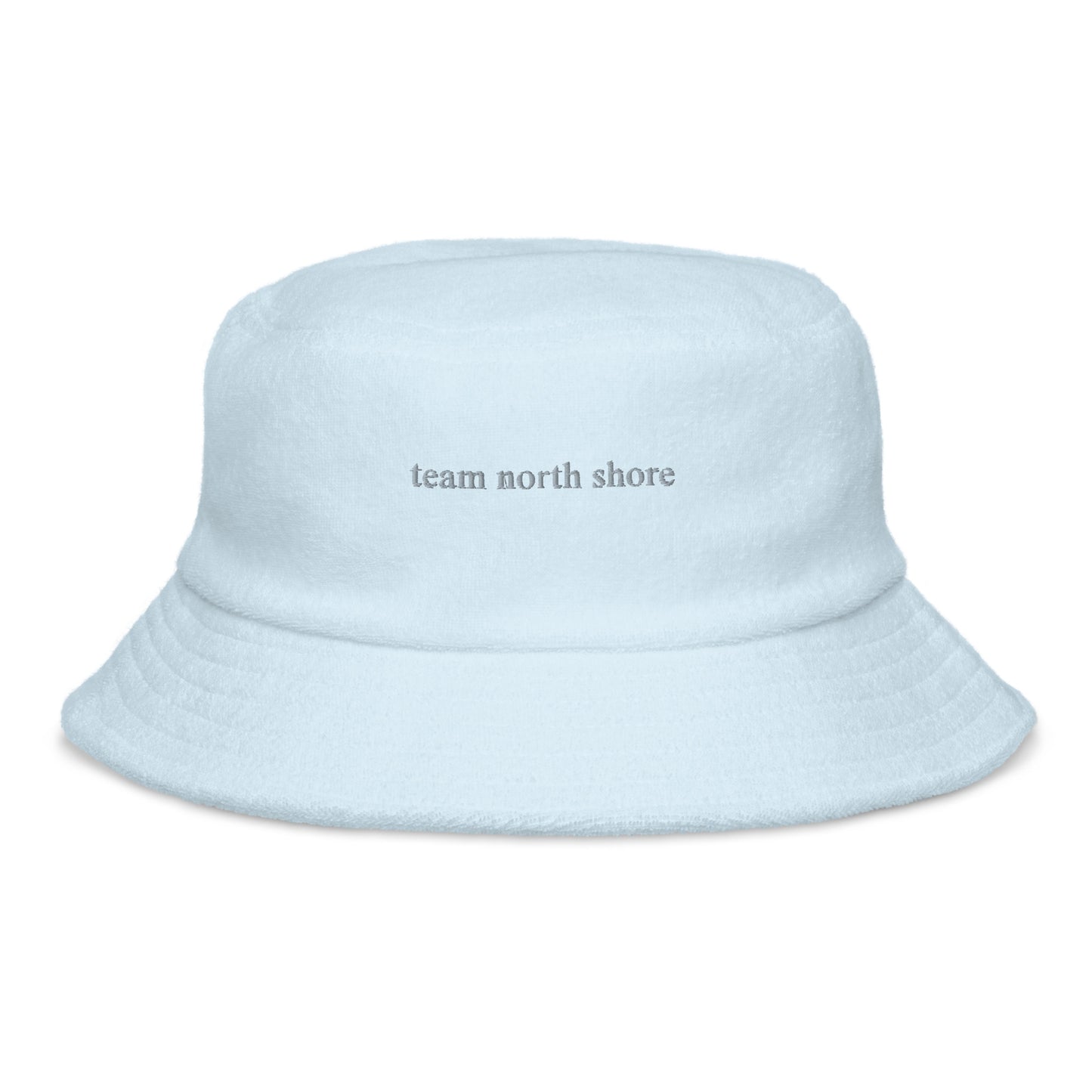 baby blue bucket hat that says "team north shore" in grey lettering