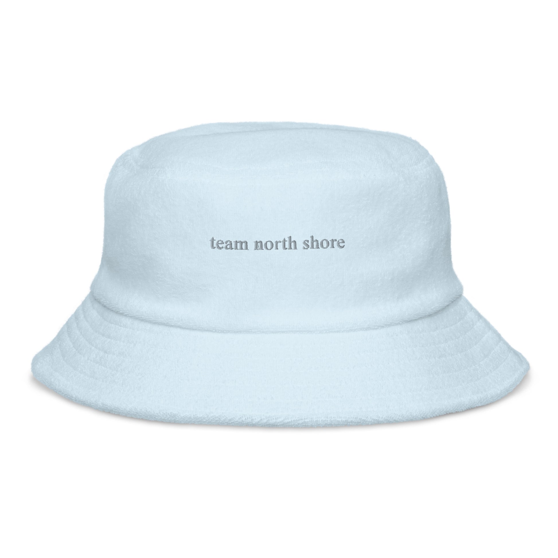 baby blue bucket hat that says "team north shore" in grey lettering