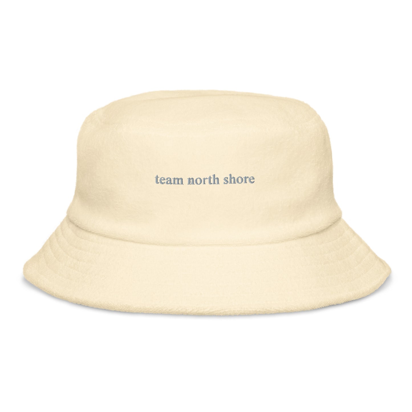 yellow bucket hat that says "team north shore" in grey lettering