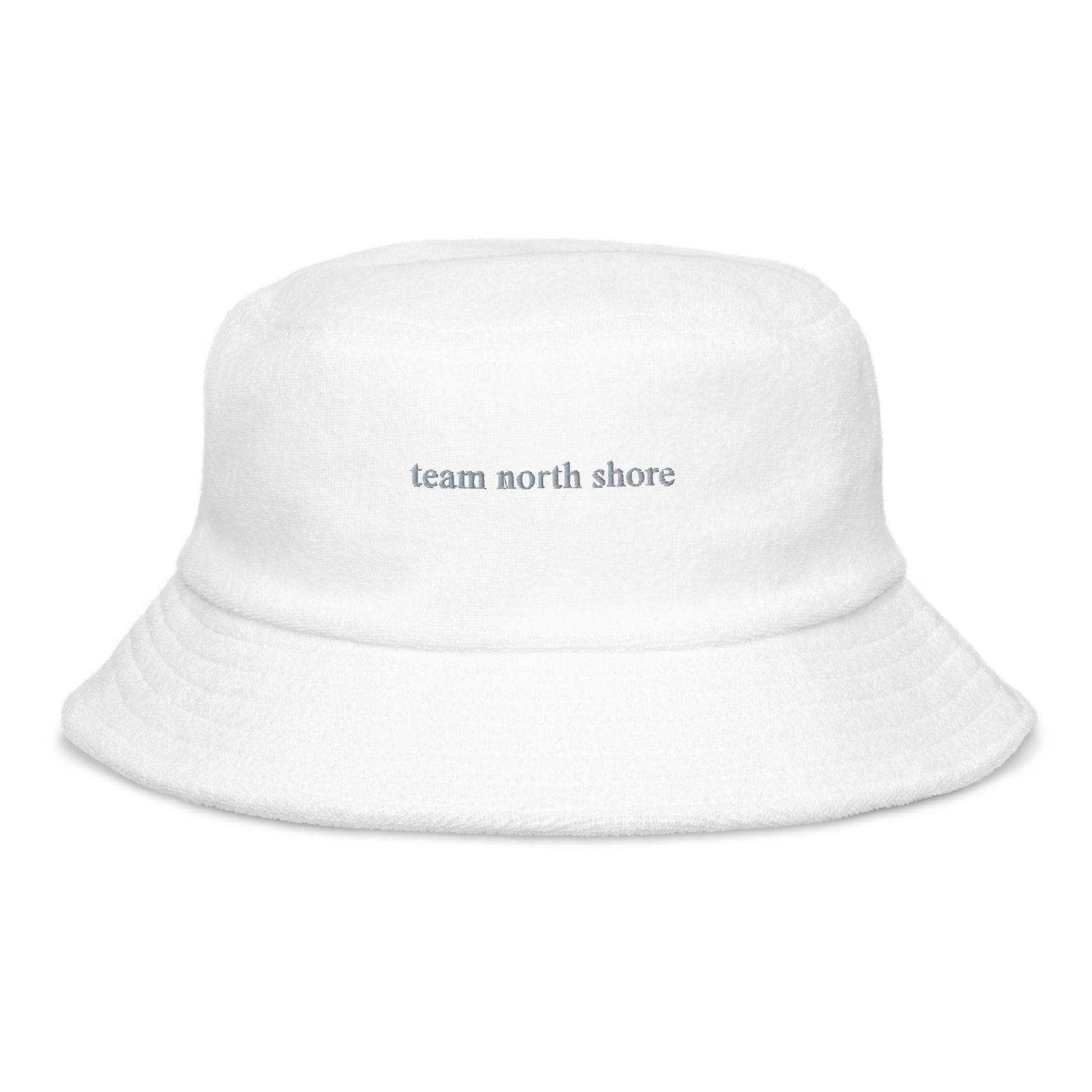 white bucket hat that says "team north shore" in grey lettering